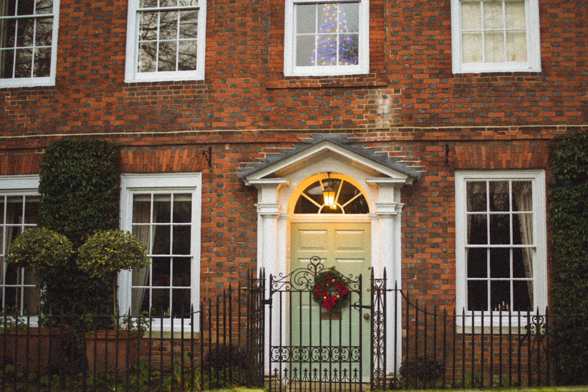 Green front door with a Christmas wreath creating a simple outdoor holiday focal point