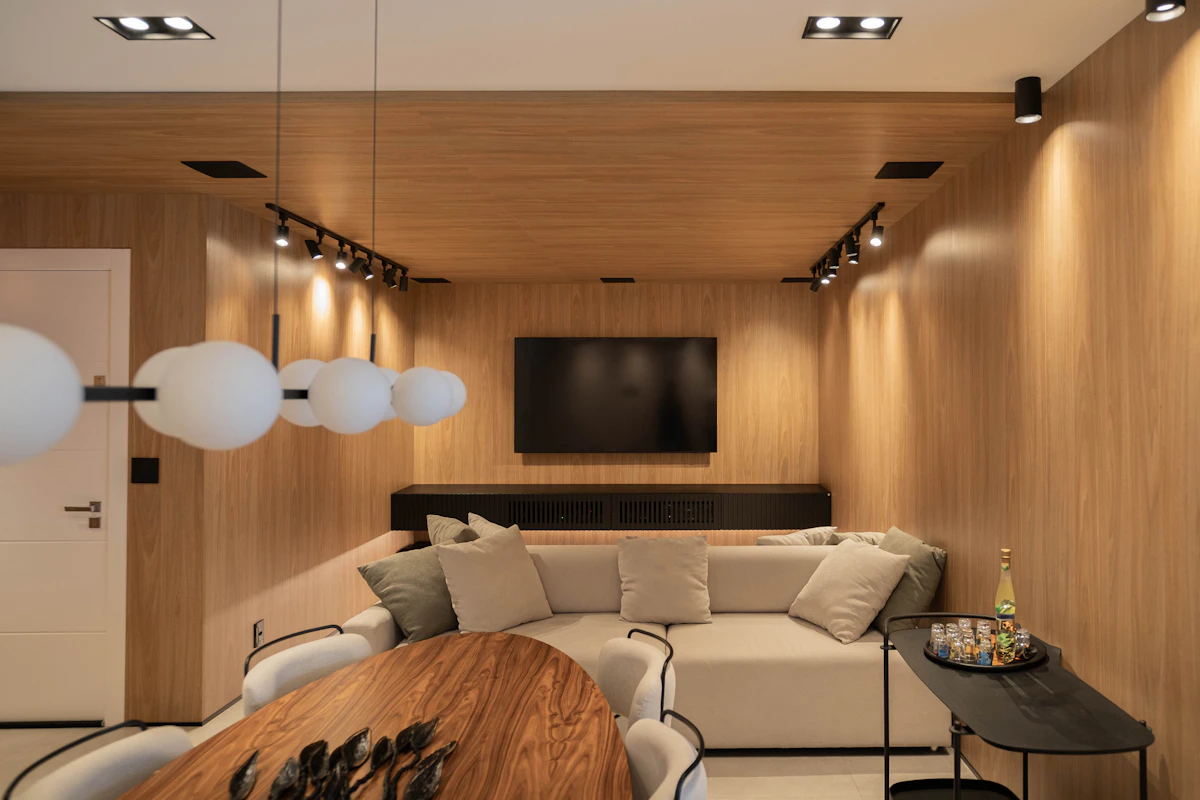 Compact modern dining area with a warm wood table and slim chairs in a small apartment