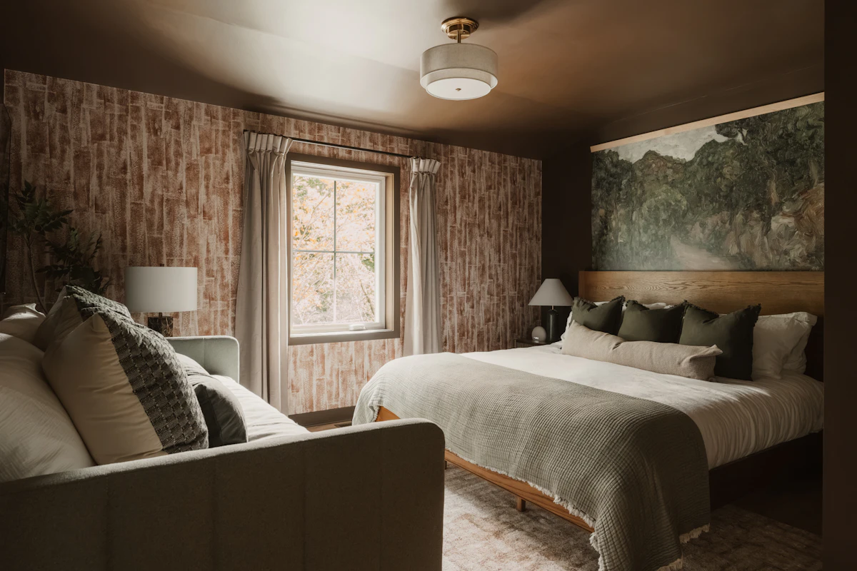 Cozy bedroom layered with warm brown neutral bedding and soft natural fall textures