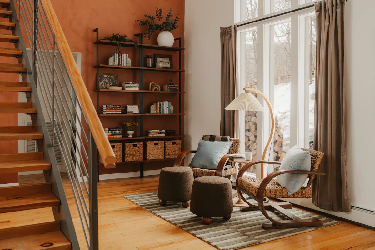 Cozy living room reading corner with an armchair, floor lamp, and layered decor