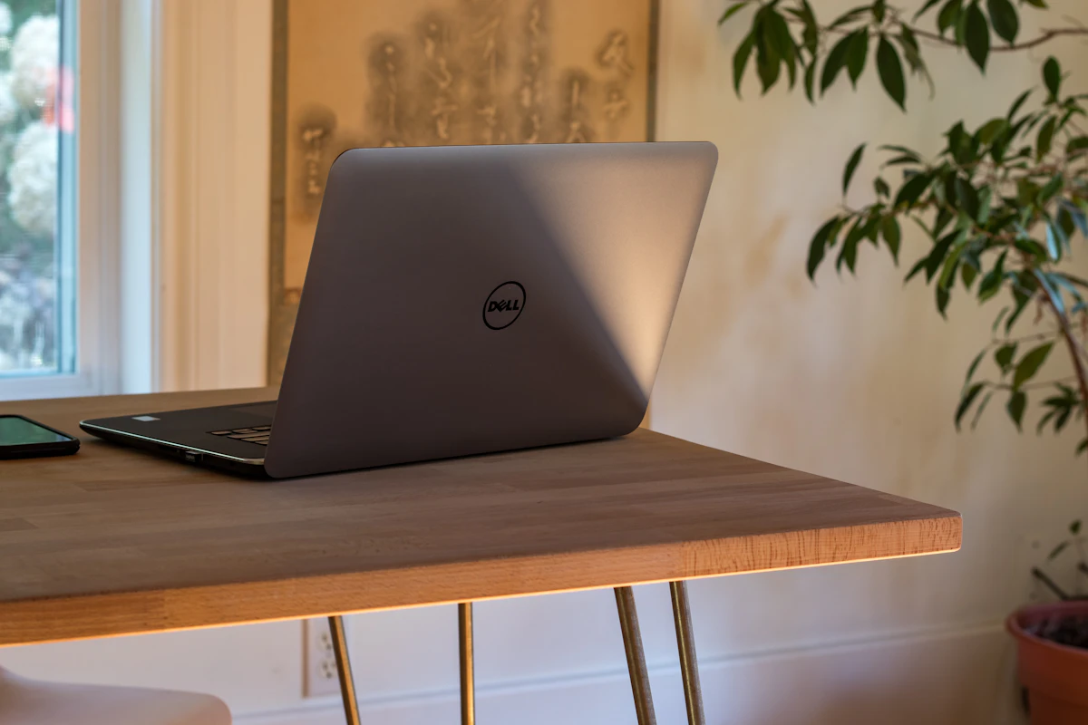 Compact dining table used as a laptop workspace in a small home