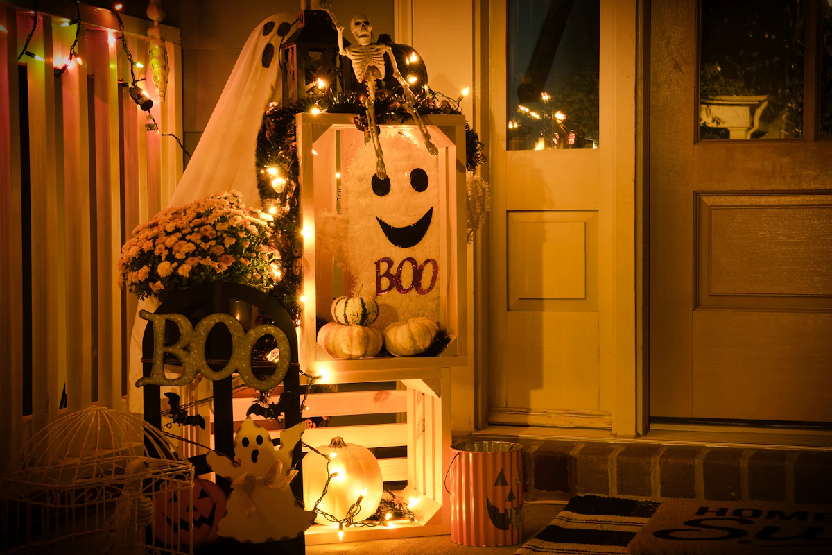 Front porch styled with seasonal decor and warm outdoor lighting at night