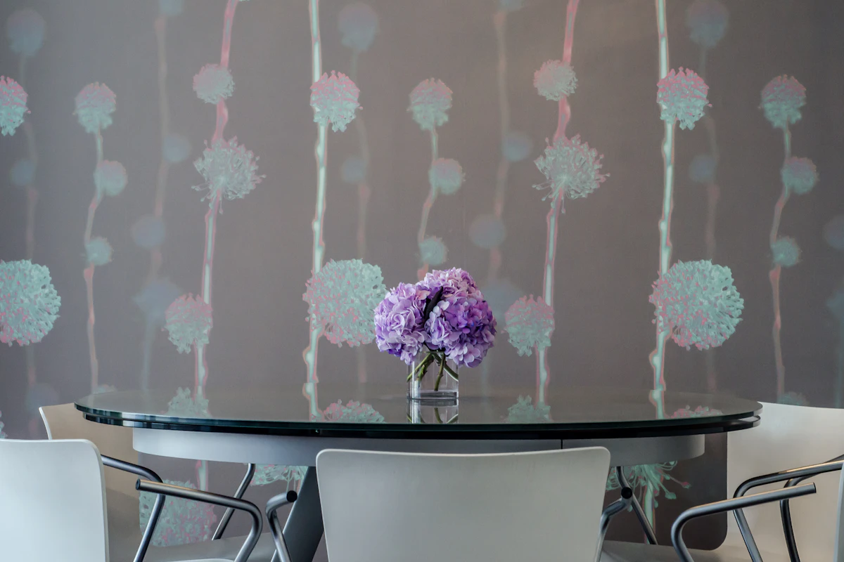 Dining room with decorative floral wallpaper creating a bold accent wall