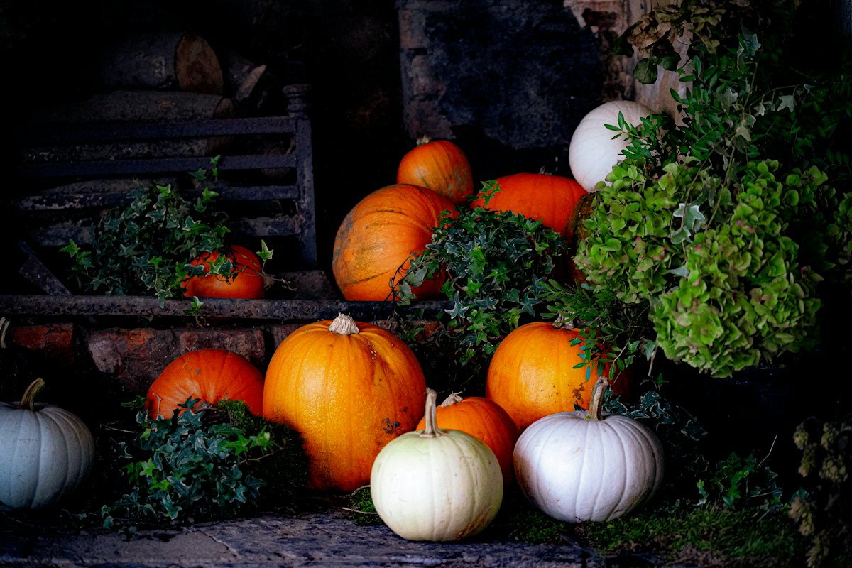 Halloween fireplace decor with pumpkins arranged around the hearth