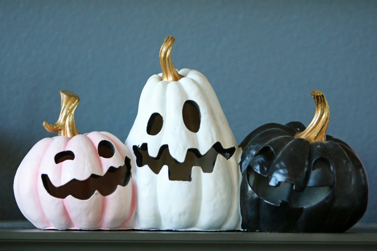 Three carved Halloween pumpkins used as spooky party decor