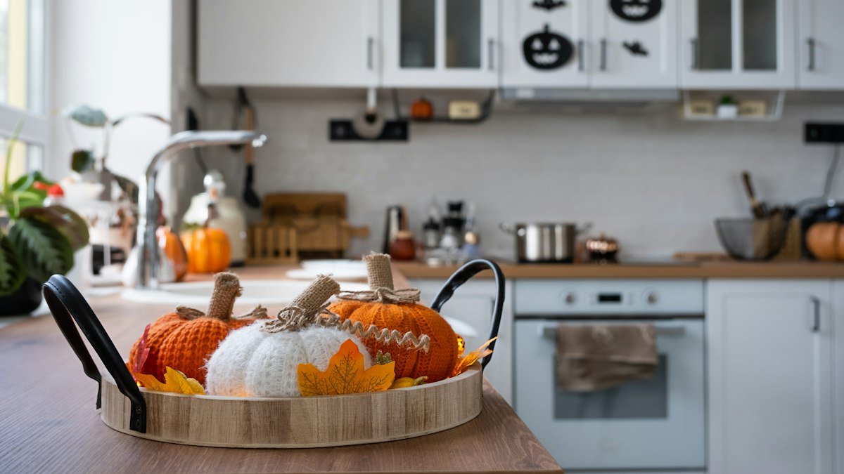 Halloween party home decor with pumpkins in a bright kitchen