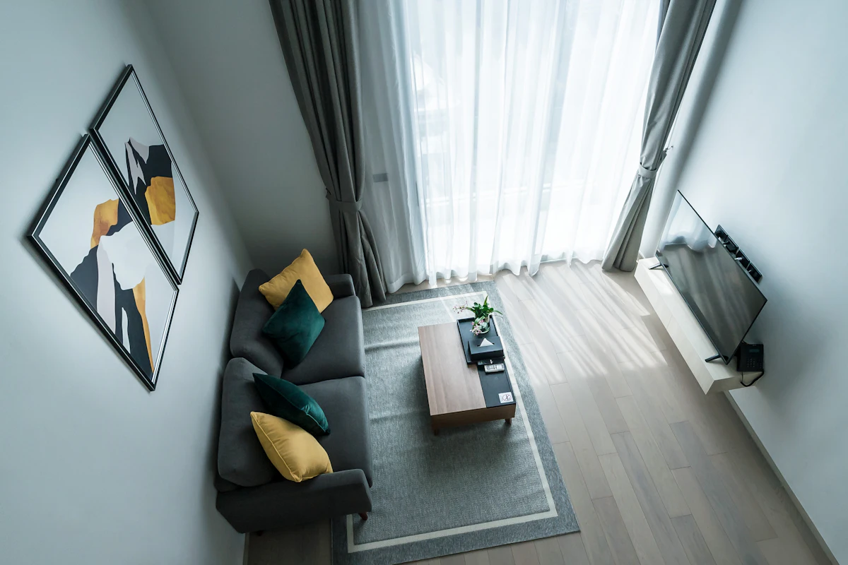 Modern living room with a low-profile sofa and clean horizontal furniture lines beneath a modest ceiling