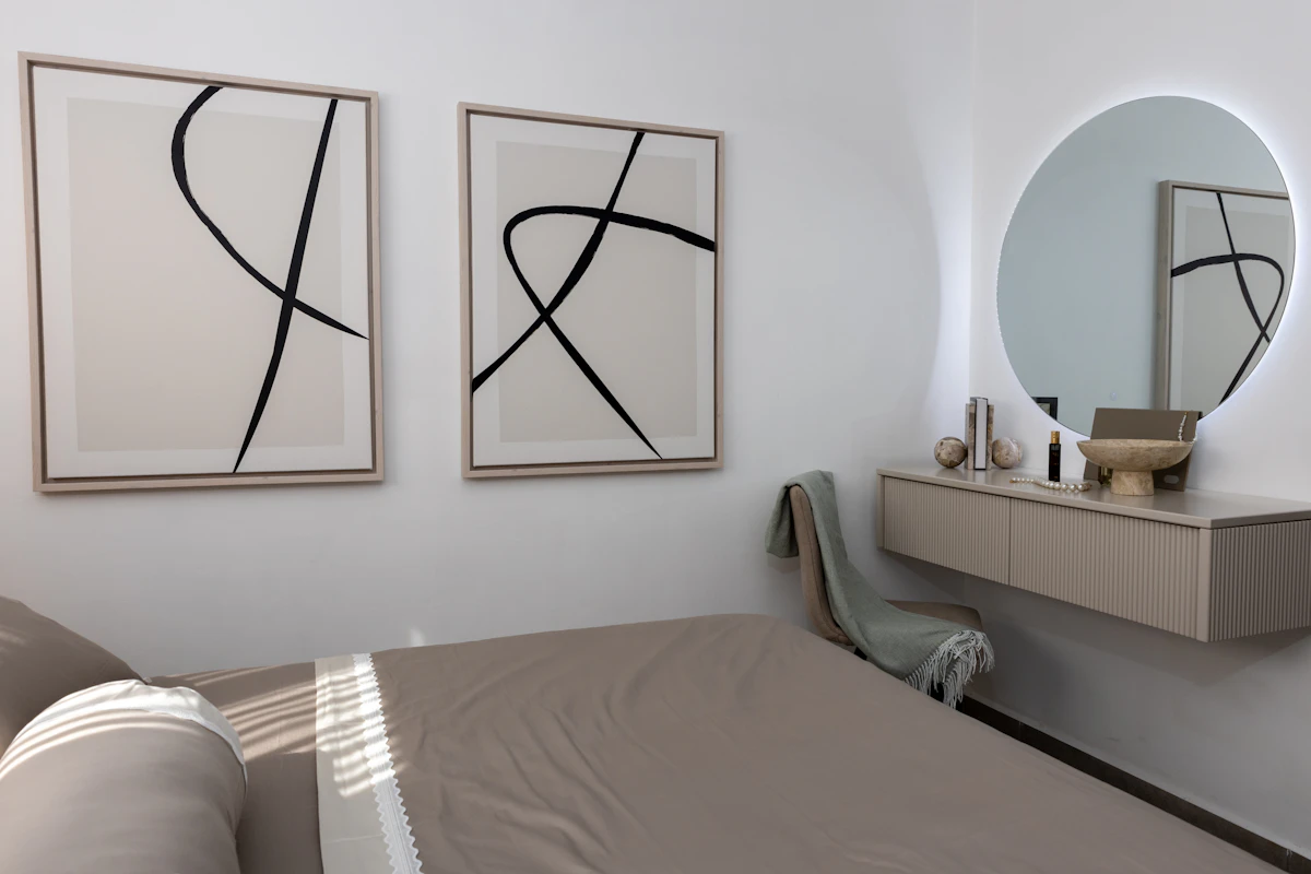 Minimal bedroom vanity with a mirror and slim dressing table in a compact room