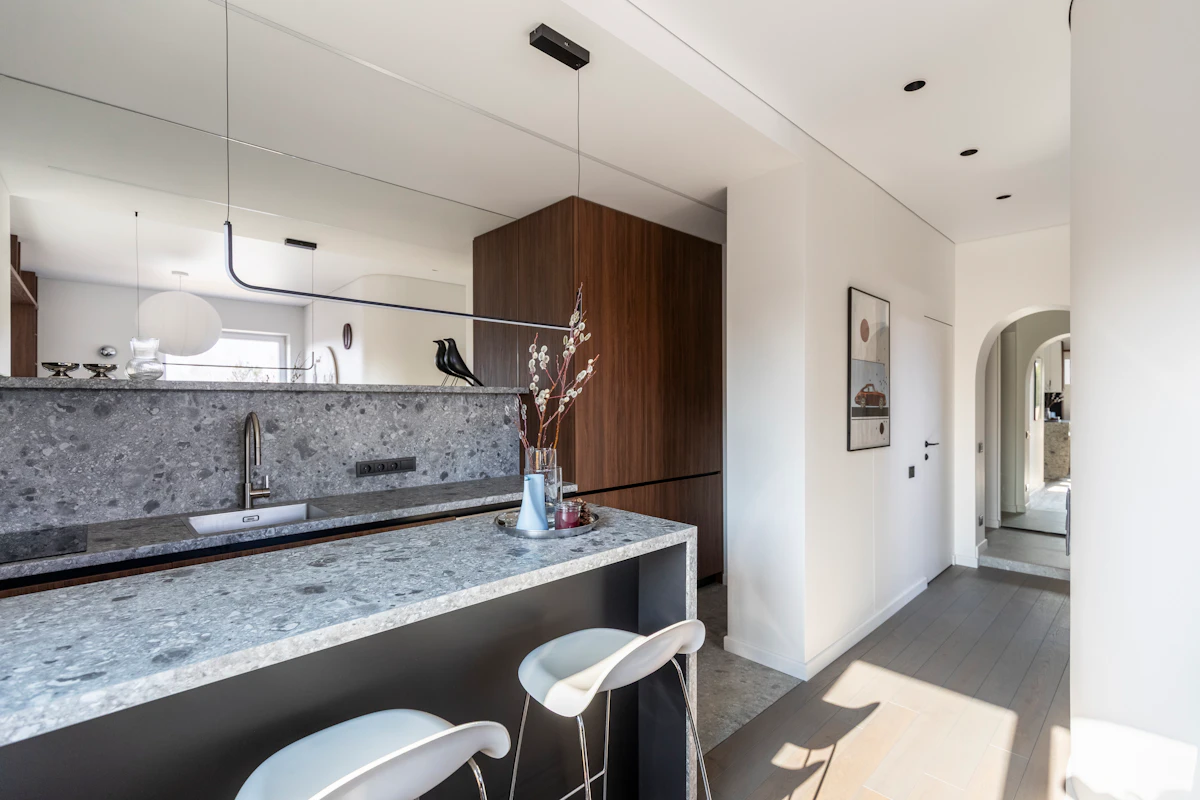 Narrow apartment hallway with a compact entry zone and warm wood finishes