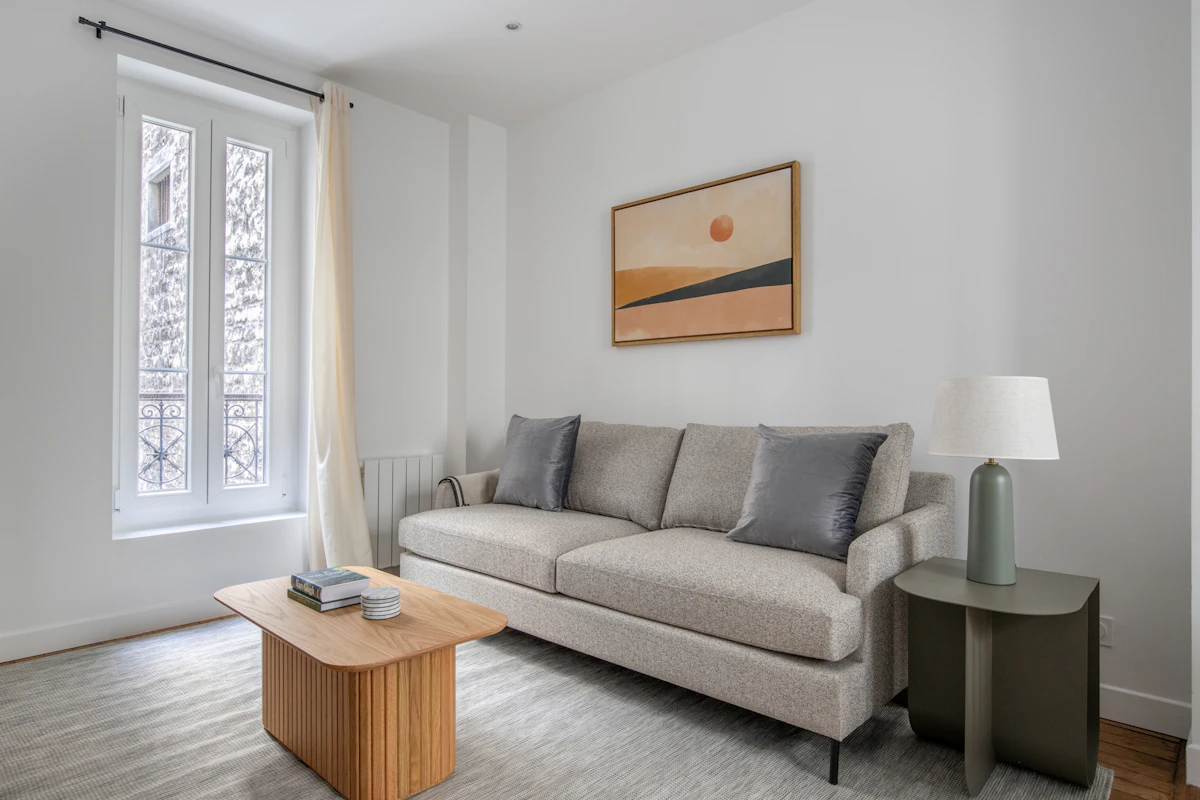Small open-plan apartment living room using portable lamps to create layered lighting