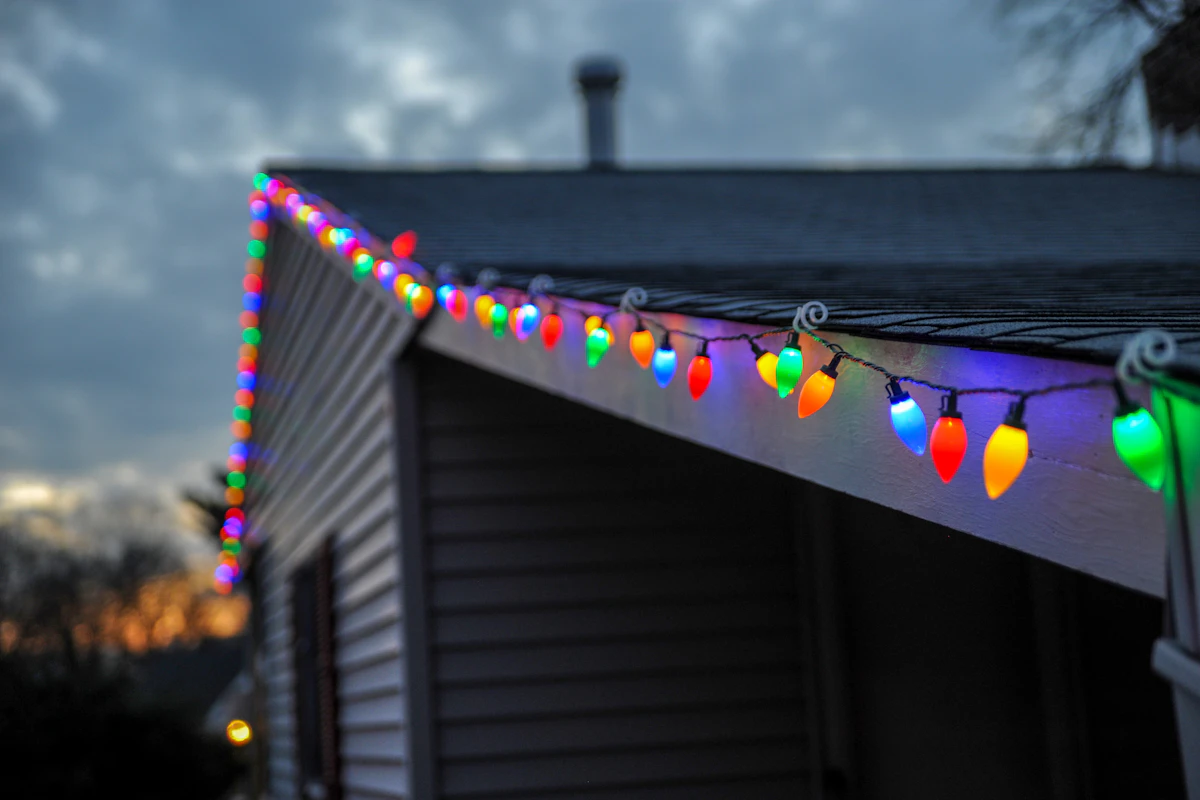 Warm white outdoor Christmas lights installed neatly along a roofline