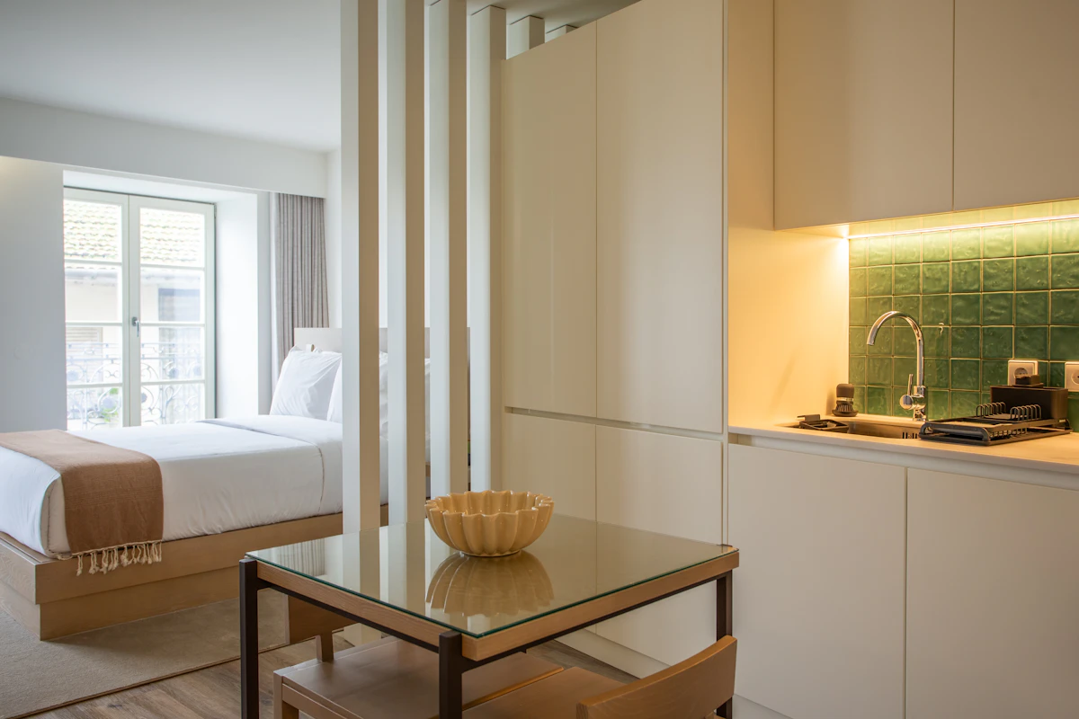 Small apartment sleeping area separated with a light wood slatted partition