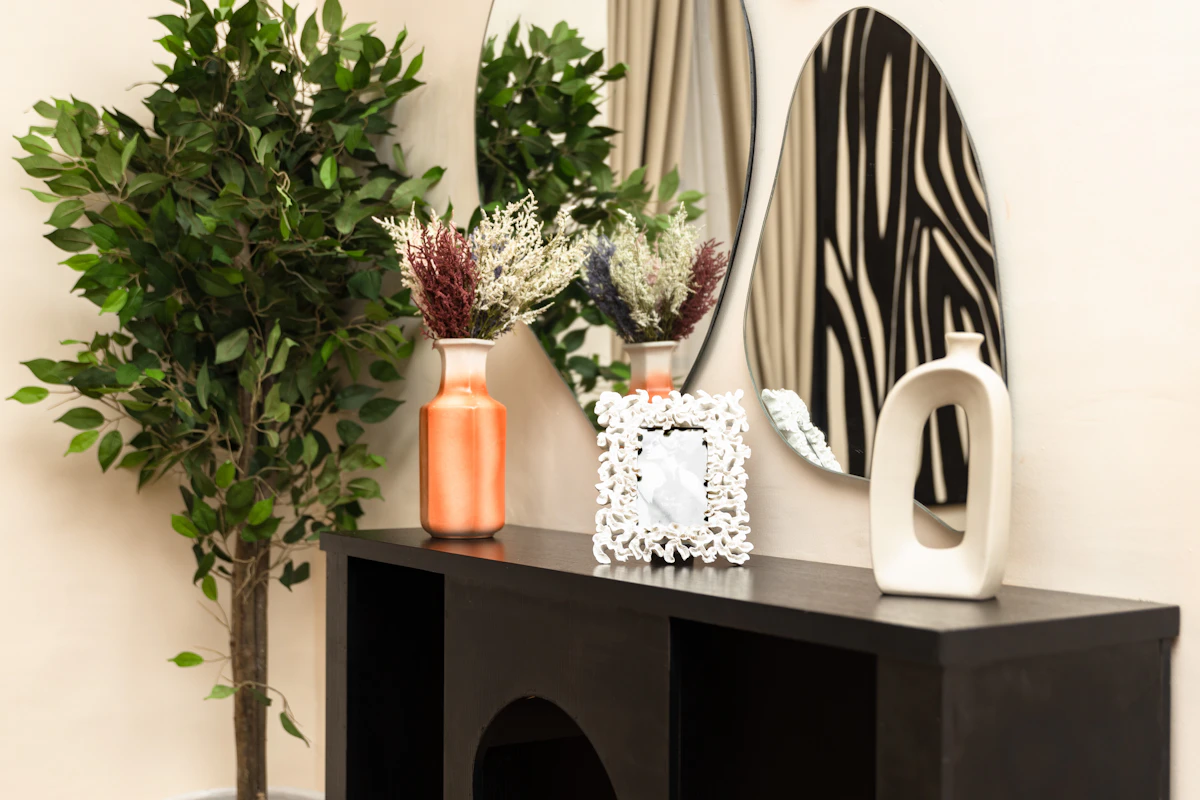 Slim entryway console with decorative mirrors and a small landing surface for daily essentials