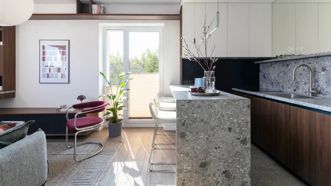 Open-plan small apartment with a compact dining area between the kitchen and living room