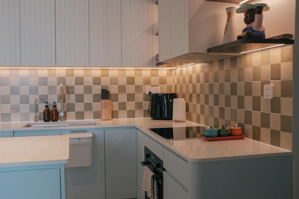 Small apartment kitchen with focused task lighting around counters and cabinets