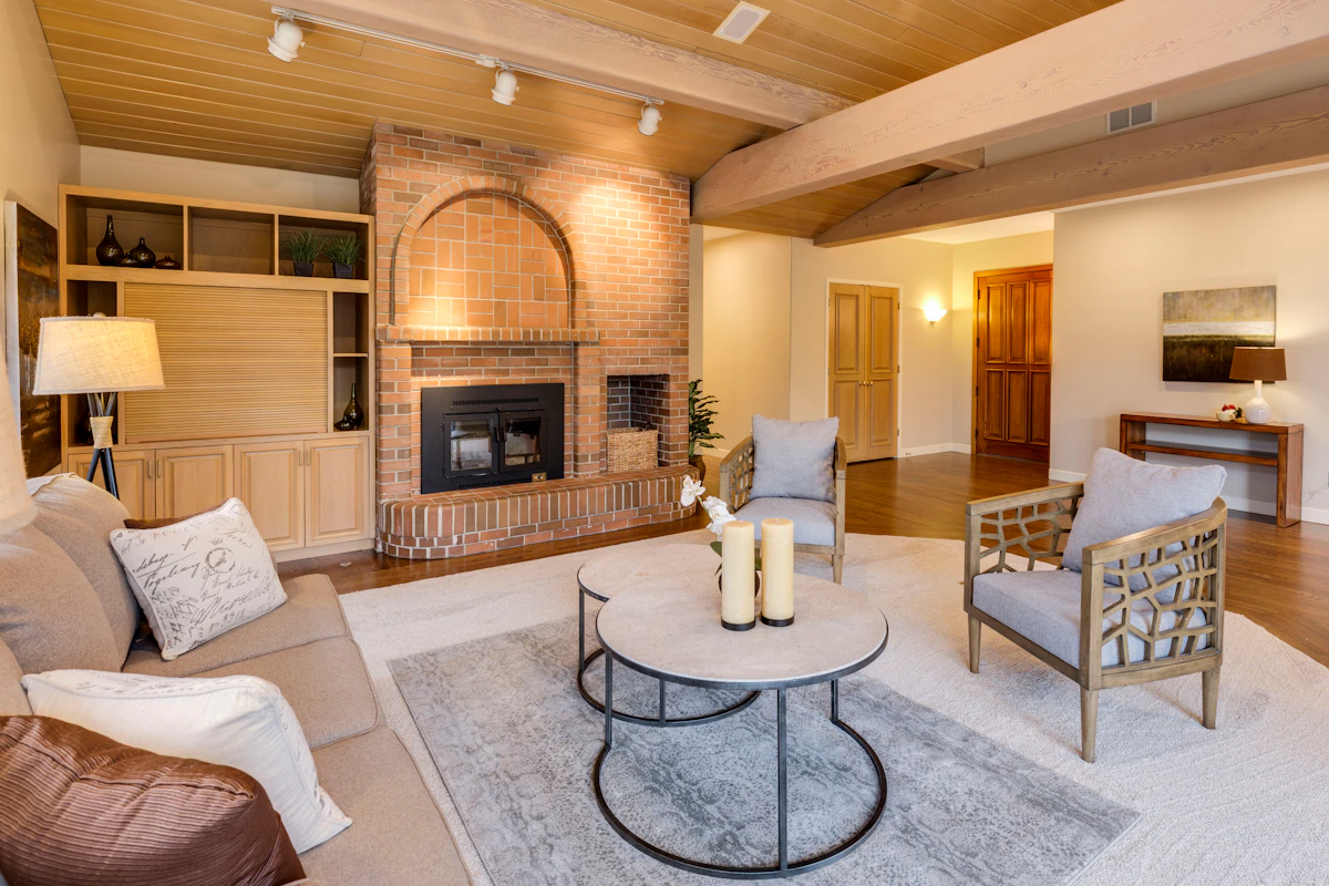 Compact living room with fireplace, coffee table, and seating arranged around a central focal point