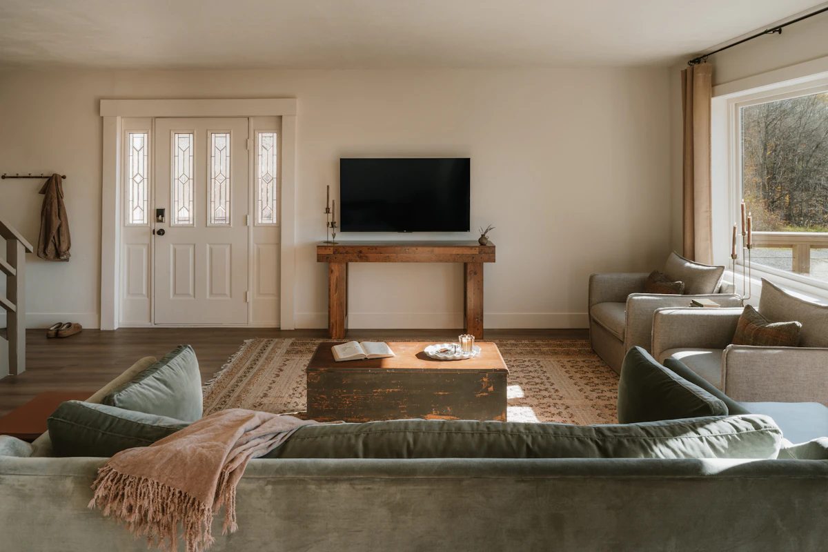 Cozy small living room with sectional seating, fireplace, and television in a practical layout