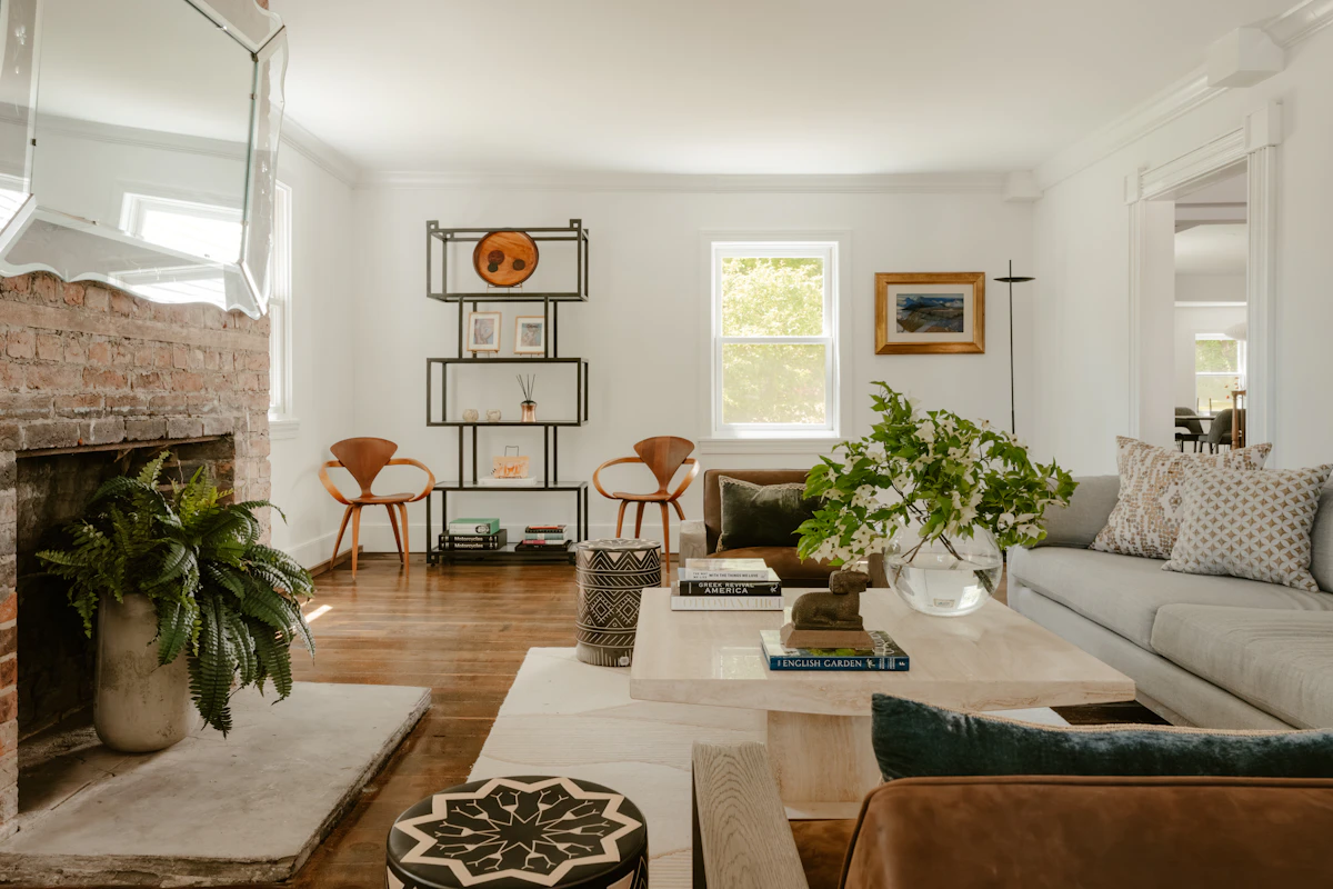 Neutral living room with television mounted above the fireplace and seating arranged for viewing