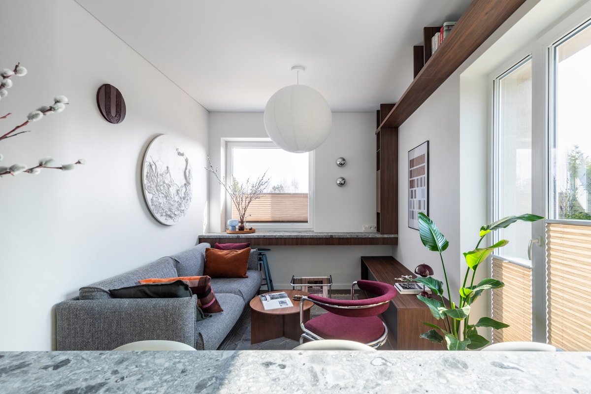 Apartment living room with a gray sofa, accent chair and cohesive neutral color palette