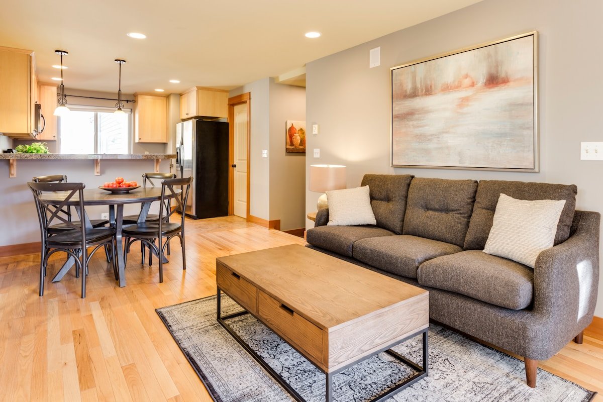 Apartment sofa and coffee table anchored by a properly scaled living room rug