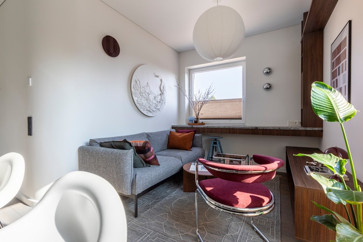 Bright apartment living room with a properly scaled sofa and armchair