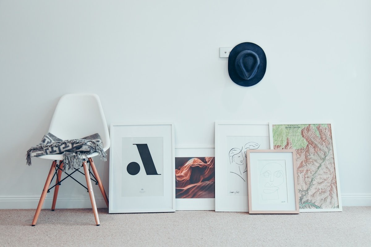 Chair beside a coordinated wall art arrangement in a compact room
