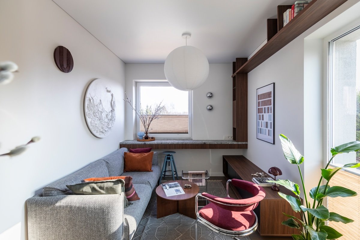 Cozy apartment living room with a sofa, armchair and a clear walking path
