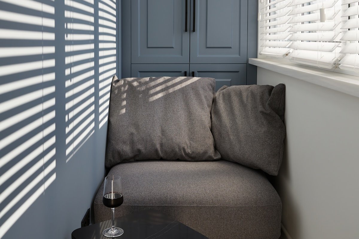 Cozy apartment reading nook with an armchair, small side table and personal decor