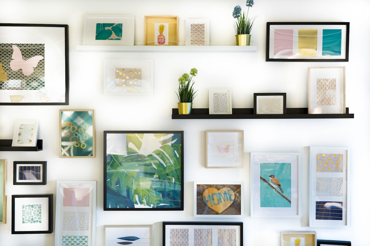 Eclectic gallery wall with framed artwork arranged over a living room console