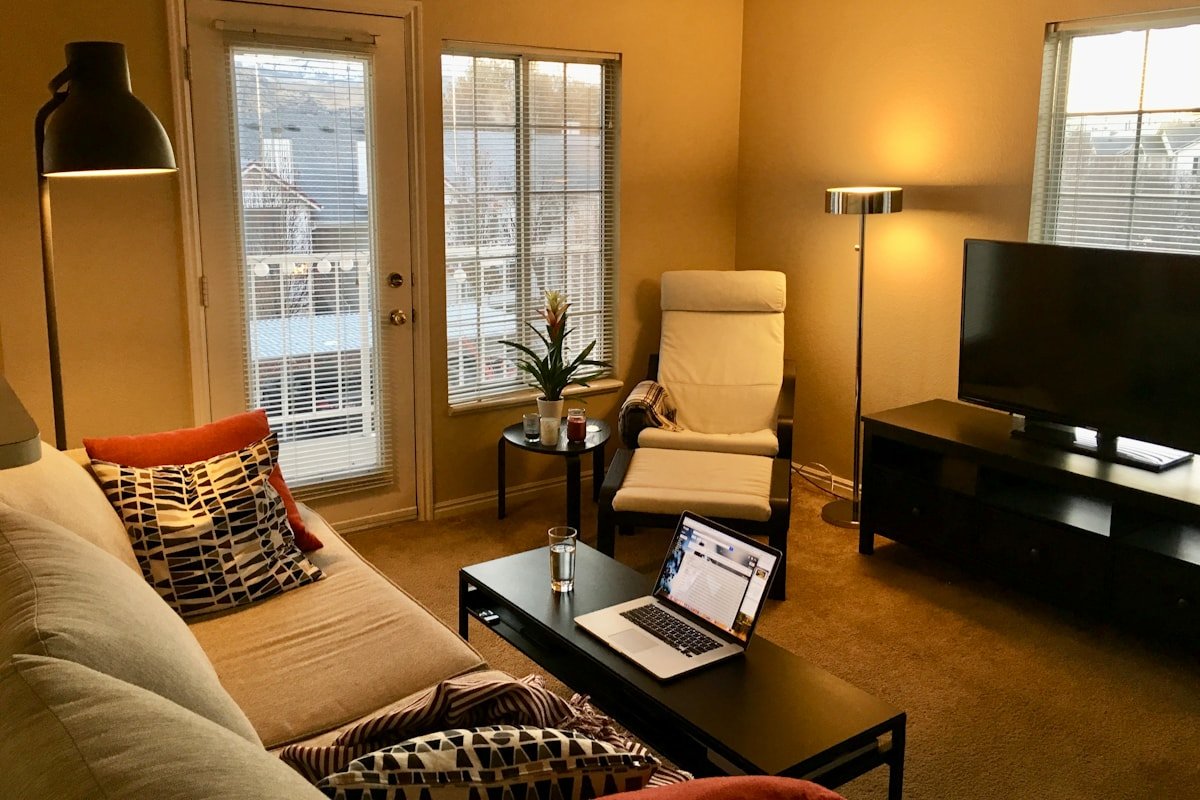 Modern apartment living room with full curtains and compact furniture