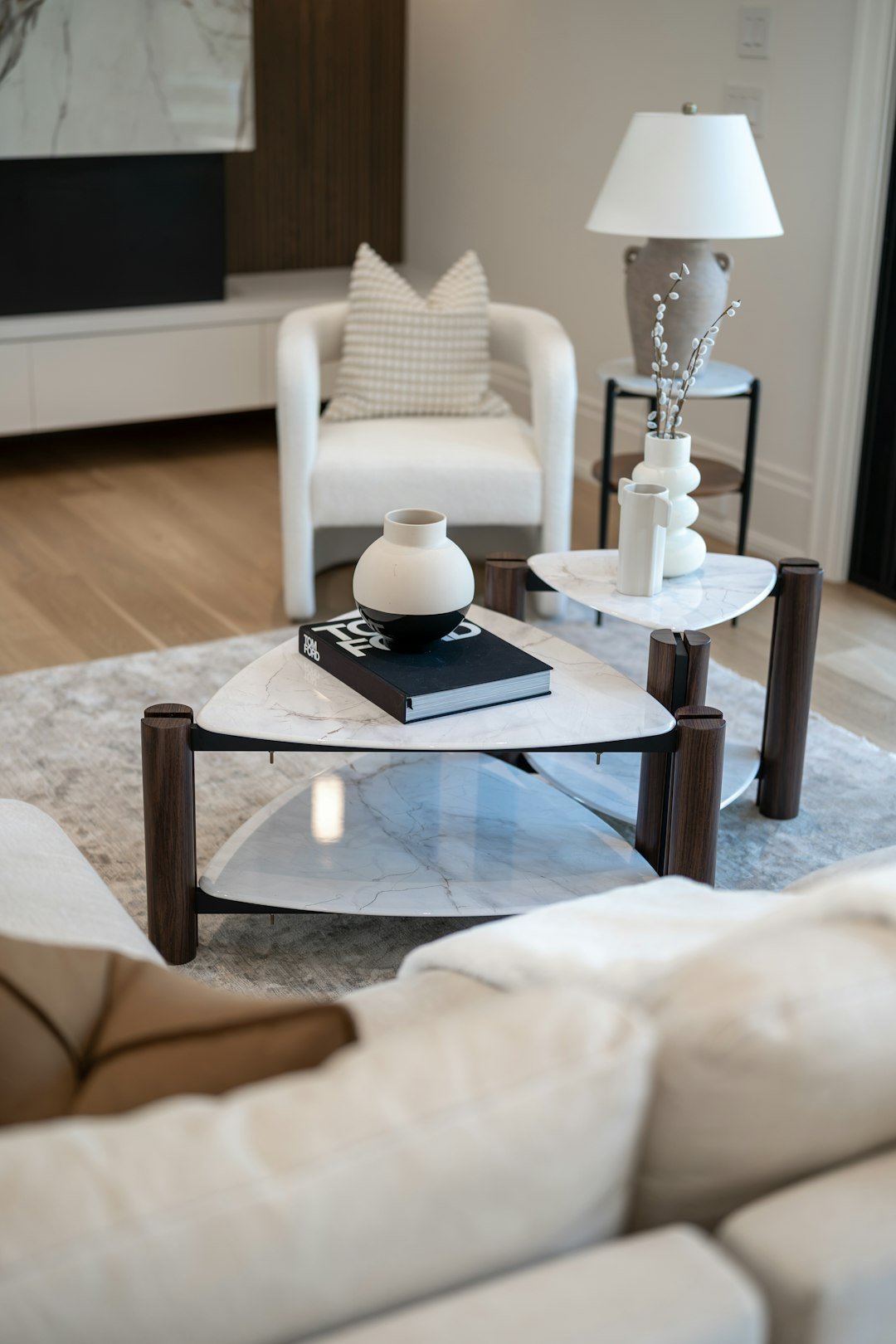 Modern living room with a sculptural triangular coffee table and restrained decor