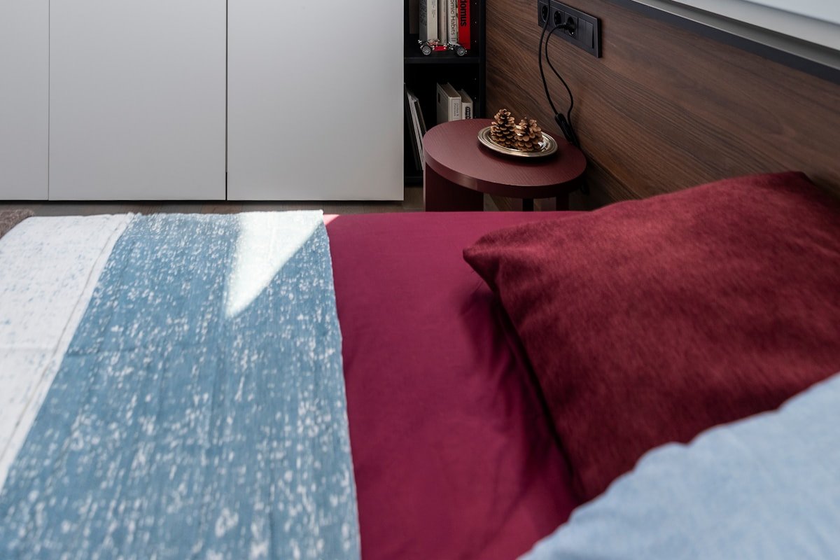 Modern small bedroom with wardrobe window and bed arranged for efficient circulation