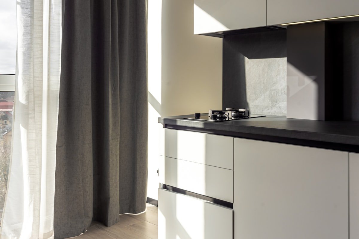 Modern small kitchen with natural light and a visually open layout