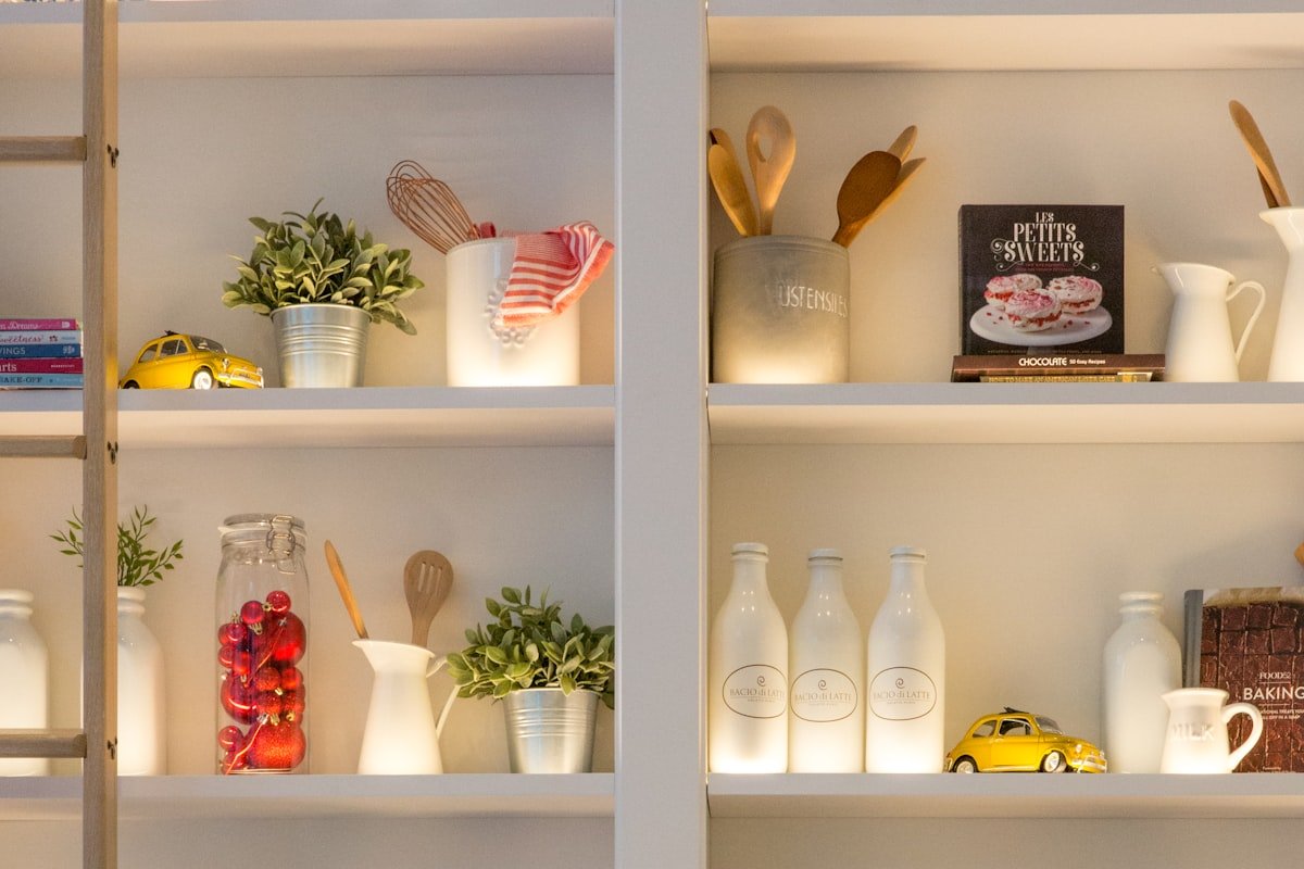 Neatly arranged white containers on a kitchen shelf for simple visible storage
