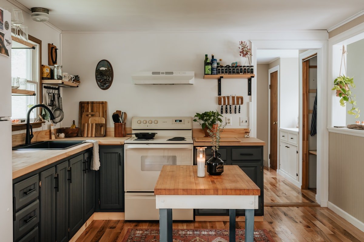 Organized compact kitchen with clear work surfaces and practical cabinet storage