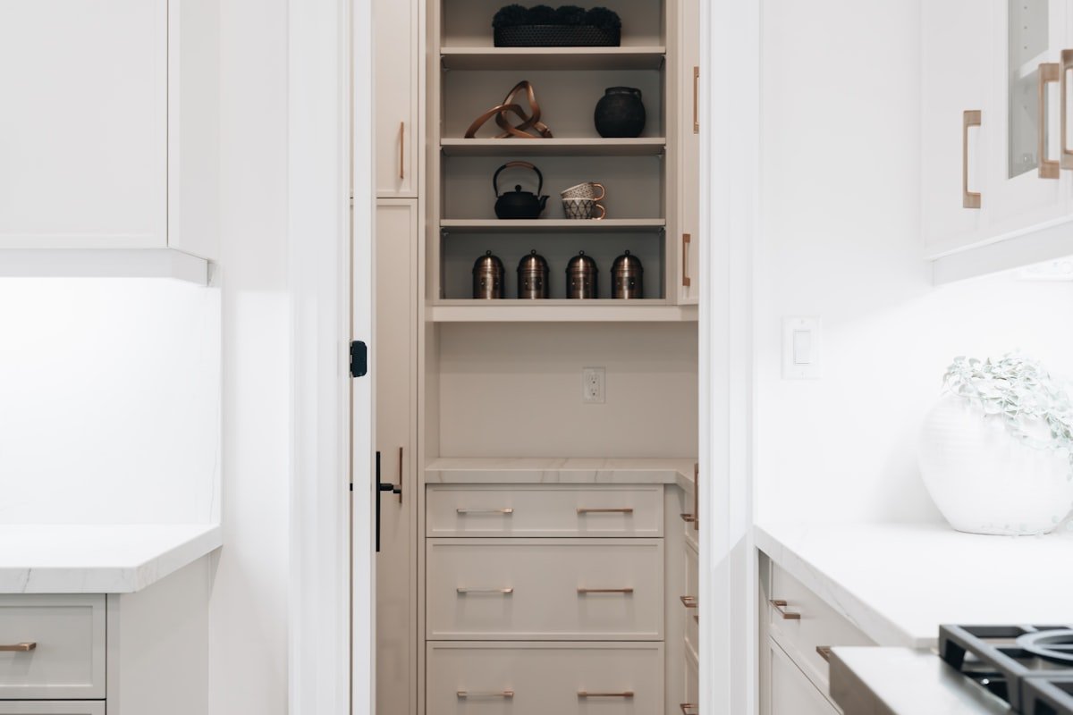 Organized pantry with open shelving and drawers for compact kitchen storage
