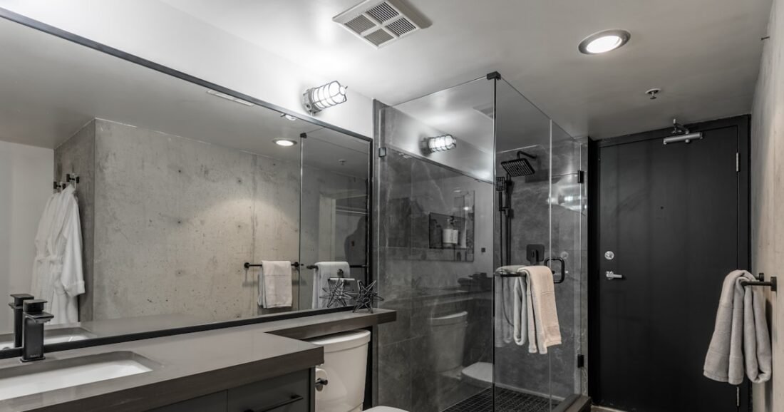 Small rental bathroom with vanity mirror shower and simple reversible decor